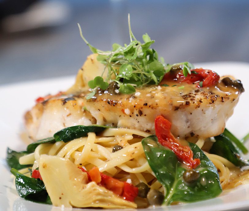 delicious pasta dish pasta dish with vegetables topped with seafood